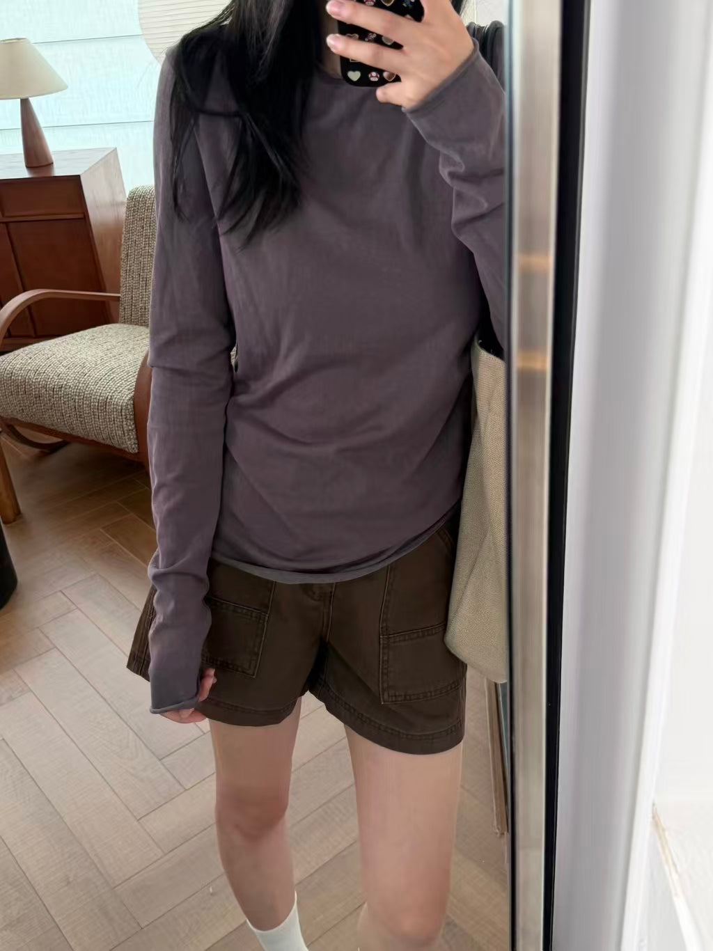 Side view of beige denim cargo shorts